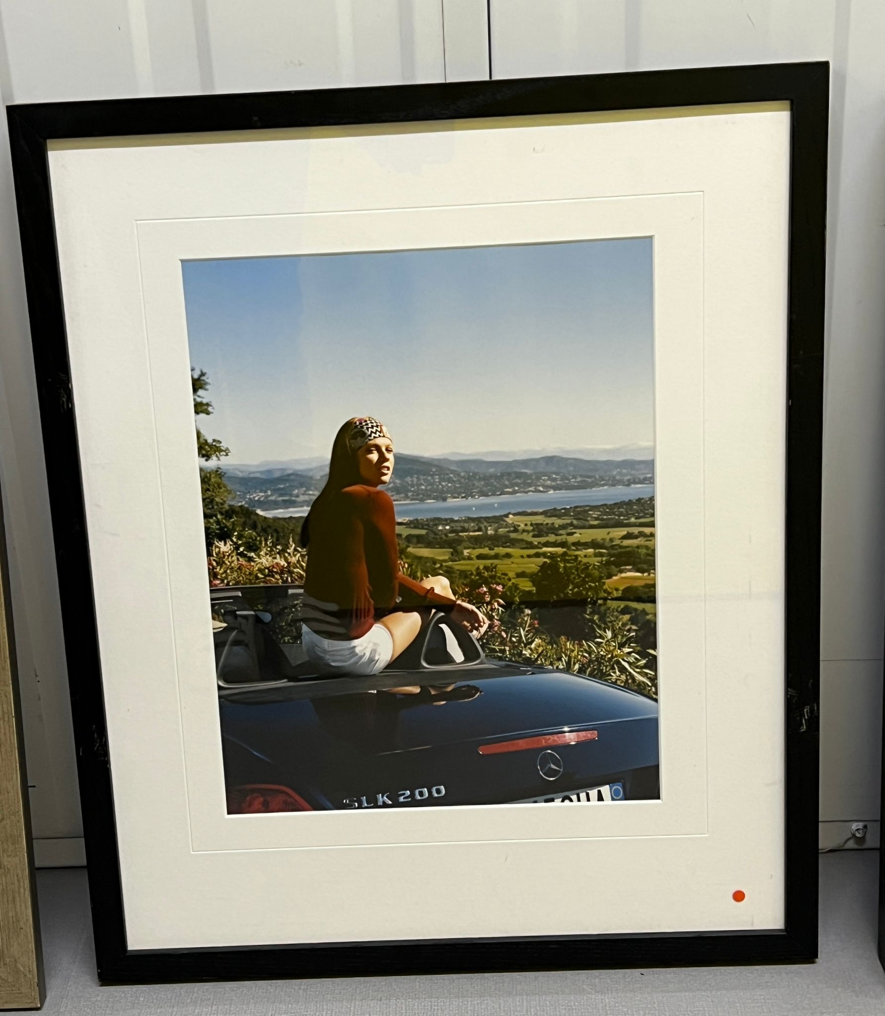 Framed photograph of a lady sat on a Mercedes SLK 2000 (Framed size 48cm x 58cm)