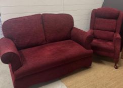 A two seater burgundy sofa with drop arms and a matching arm chair H83cm W150cm D80cm