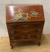 A three drawer bureau with a Chinese pastoral scene decoration