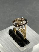 A smokey quartz and diamond ring, oval cut smoky quartz weighing on a 7.20ct claw set with a