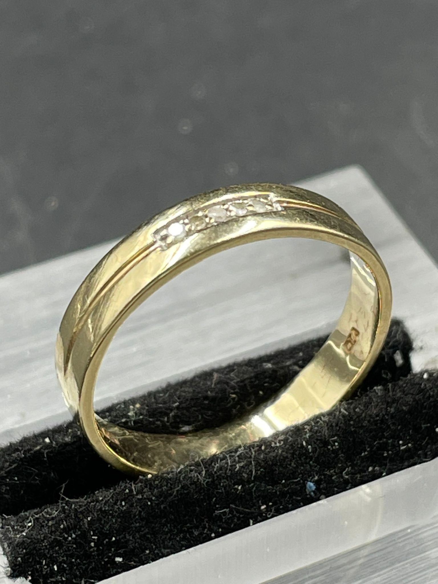 A diamond set band ring, 4mm band set with five single cut diamonds weighing an estimated total of - Image 2 of 2