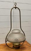 A vintage brass paraffin ceiling light with glass shade
