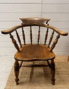 An elm Captains Elbow or desk chair on turned legs and stretcher