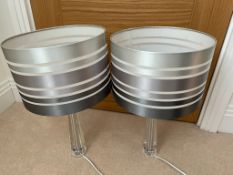 A pair of Perspex lamps with striped shades