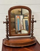 A Mahogany bathroom mirror on turned supports and demi lune base