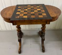 A Victorian Inlaid checkerboard / games table. On barley twist supports and scrolling legs.