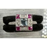 Platinum aquamarine, diamond and ruby square ring with diamond shoulders.