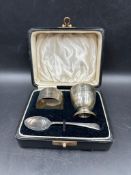 A cased set of egg cup (Engraved), napkin ring and spoon. Hallmarked by Sanders & Mackenzie for