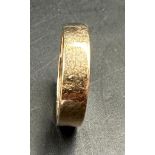 A yellow gold wedding band