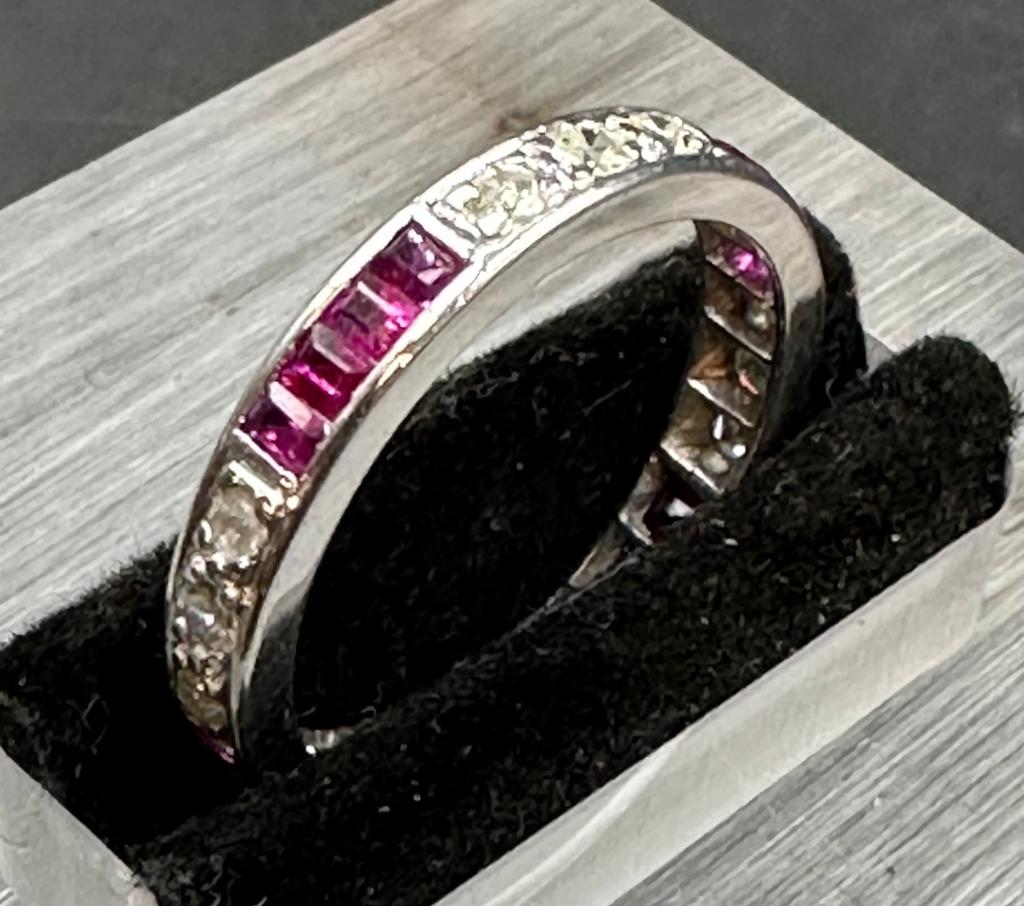 18 carat white gold ruby and diamond eternity ring.