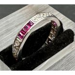 18 carat white gold ruby and diamond eternity ring.