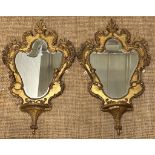 Pair of gilt gesso on wood, rococo style, Victorian girandole shield shaped mirrors fitted with a