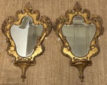 Pair of gilt gesso on wood, rococo style, Victorian girandole shield shaped mirrors fitted with a