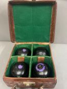 A leather case embolised LGW opening to four felted sections and four bowling balls