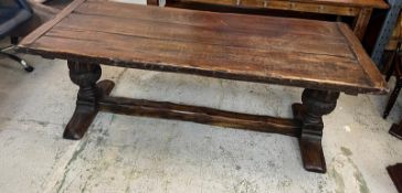 An Elizabethan jointed oak refectory table with three plank top on baluster legs and stretchers (