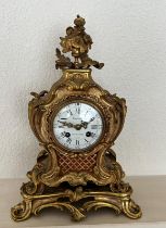 An ornate French mantle clock, eight day by Costain Galerie de la Madeleine Paris.