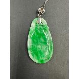 Jade pendant suspended on a 18 carat white gold 18 inch chain