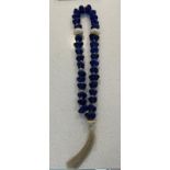 A blue glass bead necklace or worry beads (37cm)