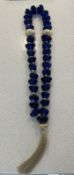 A blue glass bead necklace or worry beads (37cm)