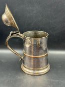 A Georgian tankard with domed and hinged cover, handle has an ornate thumb piece, height