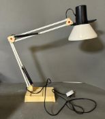An angle poise desk lamp