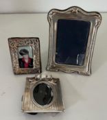 A selection of three silver photograph frames, various sizes and styles