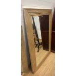 A contemporary mirror with brushed silver carved surround (110cm x 157cm) AF