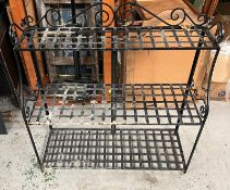A wrought iron tiered plant stand.