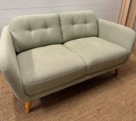 A contemporary two seater John Lewis sofa upholstered in mint green