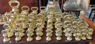 A large selection of brass scale weights