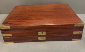 A mahogany campaign box with brass banding opening to leather lined lid and fitted interior