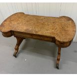 A Burr Elm Regency period library / writing table having rectangular lobed-end top above ormolu-