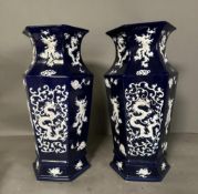 A Pair of blue and white vases on blue grounds with white dragon decoration