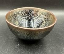 A small Chinese stoneware bowl with iridescent glaze