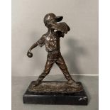 A hot cast bronze of a child playing baseball signed Nick and mounted on a marble plinth