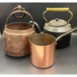A wrought iron kettle along with a hanging cooking pot and copper saucepan