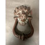 A vintage brass lions head knocker