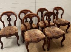 A set of six Victorian style spoon back chairs on cabriole legs with carved fleur details to backs