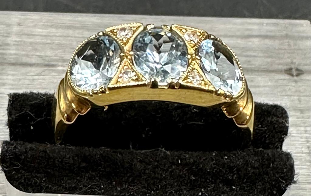 18 carat yellow gold aquamarine and diamond 3 stone ring.