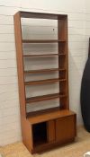 A G-Plan bookcase with four shelves and cupboard under (H98cm W76cm D48cm)