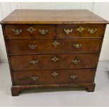 A Georgian walnut chest of drawers, two over three with brass drop handles on bracket feet (H 87cm x