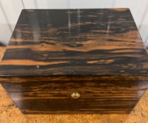 A coromandel jewellery box with fitted trays, hidden drawers (20cm x 23cm x 31cm)