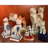 A selection of china cats on square bases/pillars