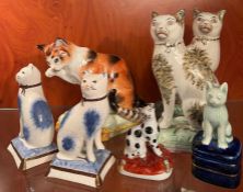 A selection of china cats on square bases/pillars