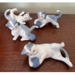 Four miniature cats stamped to base