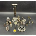A selection of white metal curios including several silver an iron and a car.