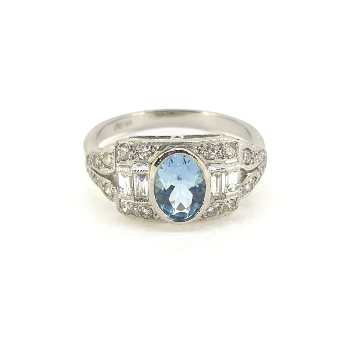 A platinum Art Deco style Aquamarine and diamond ring with baguette and round brilliant diamonds.