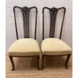 A pair of cream upholstered mahogany side chairs