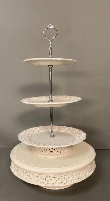 A White ceramic cake stand with pierced floral detail