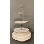A White ceramic cake stand with pierced floral detail